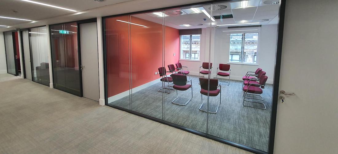 Team conducting glass partition installation